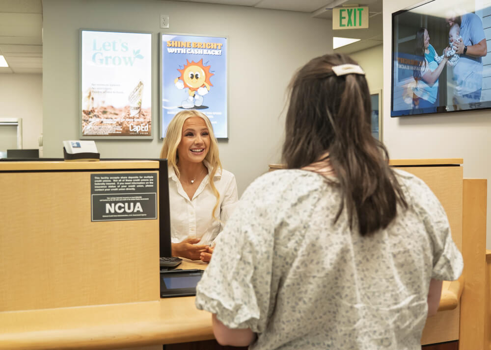 CapEd teller helping a member in a branch.