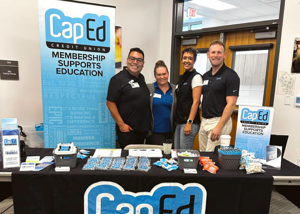 CapEd staff members doing community outreach at an event.
