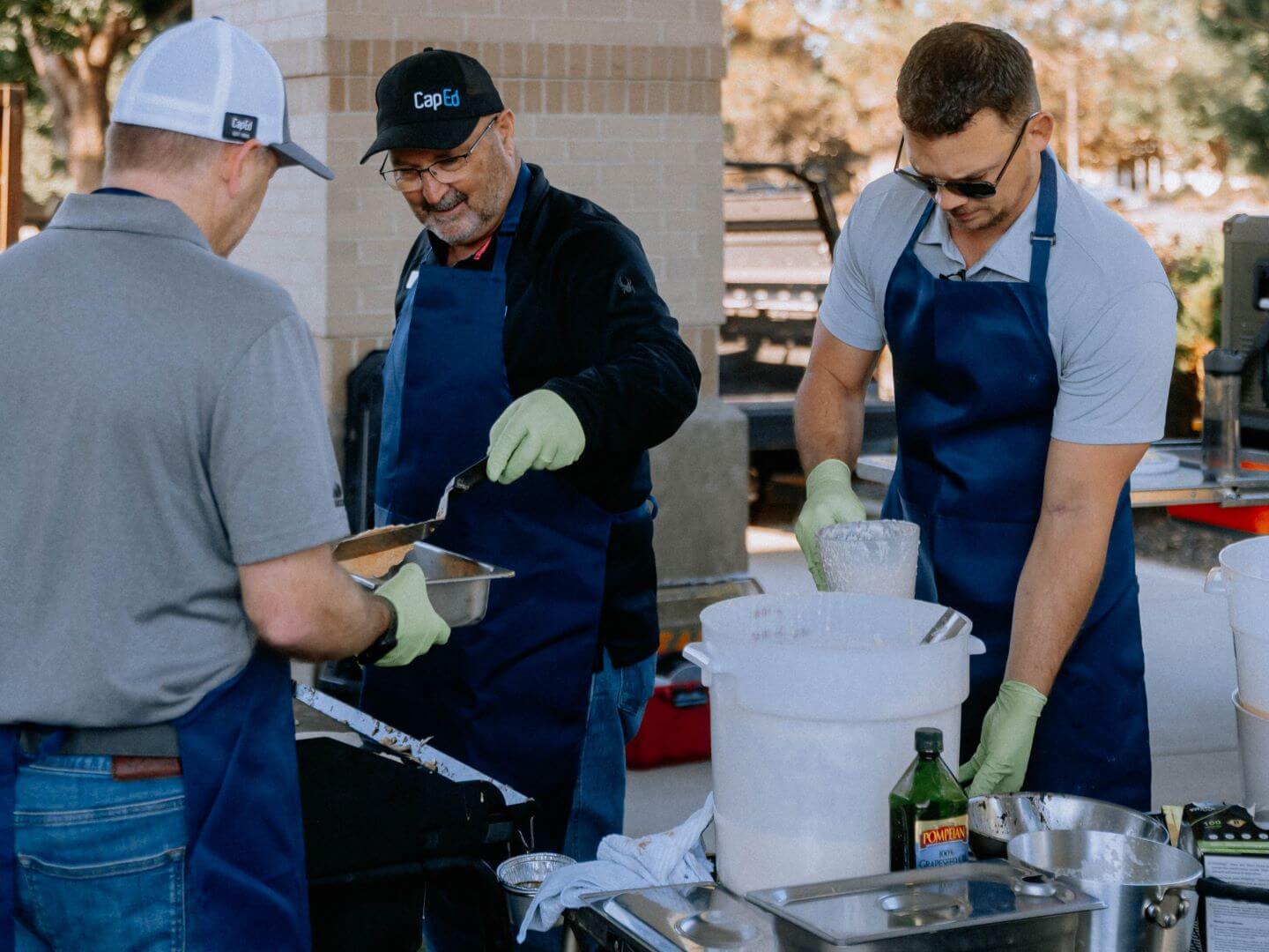 CapEd executive team members serving breakfast during an employee appreciation event.
