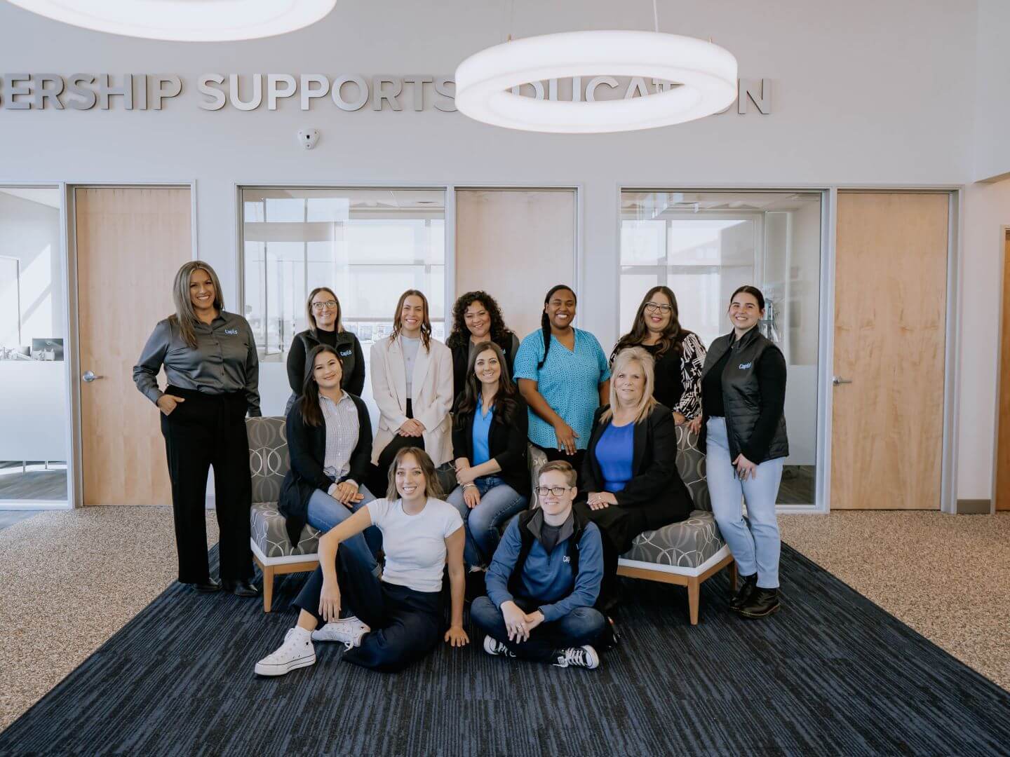 Twelve CapEd staff members celebrating receiving an Empowering Women Award.