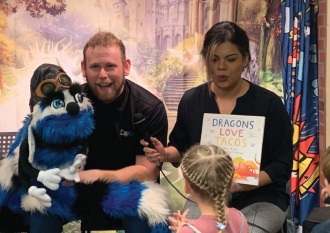 Ed Word presenting the book Dragons Love Tacos.